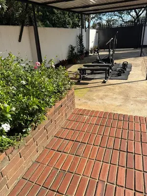 a patio with benches and a brick walkway at Petron home in Kempton Park