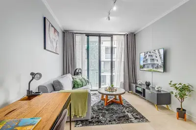 a living room with a couch and a table at 4316 Ellipse luxury Apartment, Waterfall in Midrand