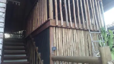 a wooden fence with a staircase in front of a building at Do Drop In in Hoedspruit
