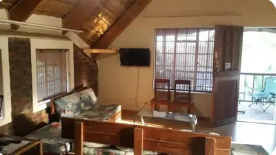 a living room with a couch and a table at Do Drop In in Hoedspruit