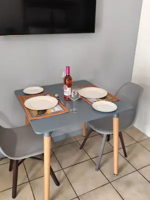 a blue table with two chairs and a bottle of wine at 899 On Burlington in Pretoria