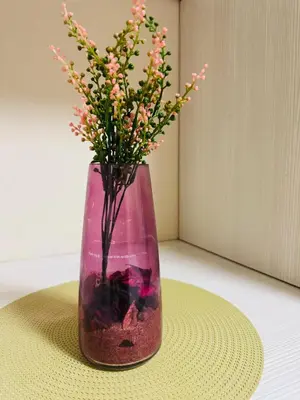 a pink vase with flowers in it on a table at C-Rane Lodge B in Phalaborwa