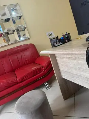 a red couch sitting next to a counter in a room at C-Rane Lodge B in Phalaborwa