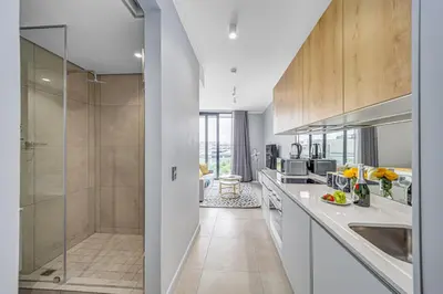 a kitchen with a walk in shower and a sink at Skyline Serenity in Midrand