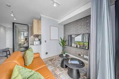 a living room with a couch and a table at Skyline Serenity in Midrand