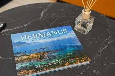 a book sitting on a table with a bottle of perfume at Skyline Serenity in Midrand