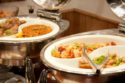 a buffet with three plates of food on a table at Tzaneen Country Lodge in Tzaneen