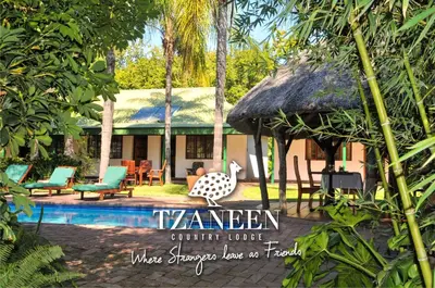 a resort with a swimming pool and a building at Tzaneen Country Lodge in Tzaneen