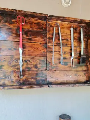 four utensils are hanging on a wooden wall at Impala Lily Kaya in Marloth Park