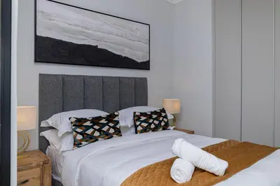 a bedroom with a bed with two towels on it at The Orbit in Midrand