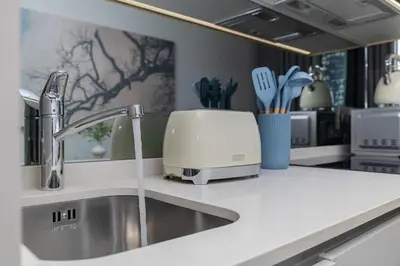 a kitchen counter with a sink and a toaster at The Orbit in Midrand