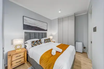 a bedroom with a bed with two towels on it at The Orbit in Midrand