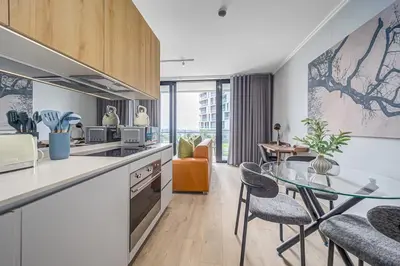 a kitchen with a glass table and a dining room at The Orbit in Midrand