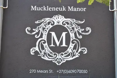 a sign for a michigeville manor with a monogrammed at Muckleneuk Manor in Pretoria