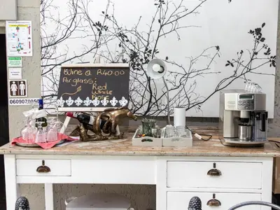 a table with a coffee maker and a sign on it at Muckleneuk Manor in Pretoria
