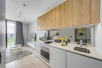 a kitchen with a sink and a counter top at Golden Sun Suites in Midrand