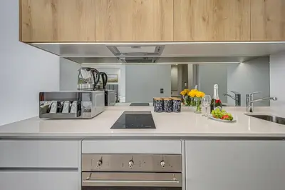 a kitchen with a sink and a counter top at Golden Sun Suites in Midrand