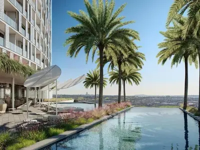 a swimming pool with palm trees next to a building at Ellipse Luxurious Tamarind Green Studio Experience in Midrand