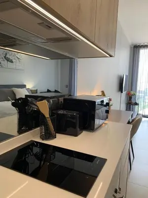 a kitchen with a counter top with a microwave at Ellipse Luxurious Tamarind Green Studio Experience in Midrand