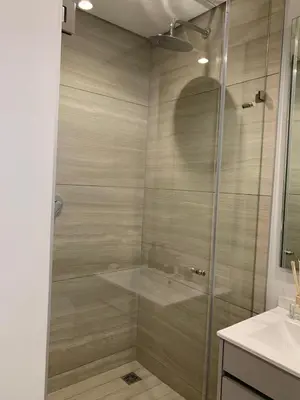 a shower with a glass door in a bathroom at Ellipse Luxurious Tamarind Green Studio Experience in Midrand