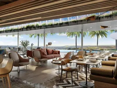 a restaurant with tables and chairs and a view of the ocean at Ellipse Luxurious Tamarind Red Studio Experience in Midrand