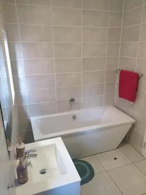 a bathroom with a white tub and a sink at 3 Bedroom Apartment The Blyde Crystal Lagoon in Pretoria