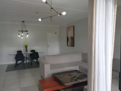 a living room with a couch and a table at 3 Bedroom Apartment The Blyde Crystal Lagoon in Pretoria
