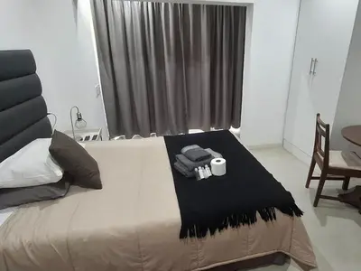 a bedroom with a bed with a roll of toilet paper on it at Green Haven Guest Lodge in Pretoria