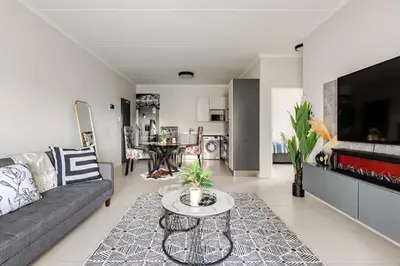 a living room with a couch and a table at Spacious Executive Luxury Apartment in Midrand