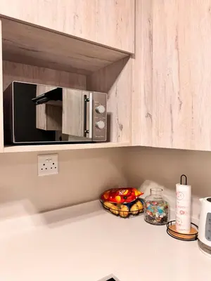 a kitchen counter with a microwave on a counter top at Spacious Executive Luxury Apartment in Midrand