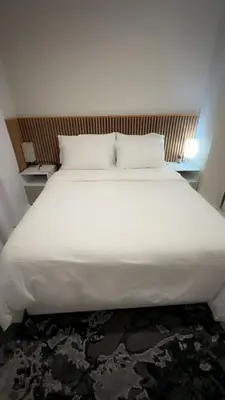 a large white bed with two pillows in a room at Spacious Executive Luxury Apartment in Midrand