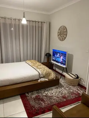 a bedroom with a bed and a flat screen tv at Blyde Lagoon View Facing Crystal 2 Large Bedrooms in Pretoria