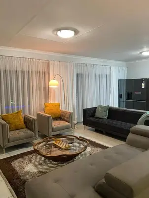 a living room with a couch and a coffee table at Blyde Lagoon View Facing Crystal 2 Large Bedrooms in Pretoria