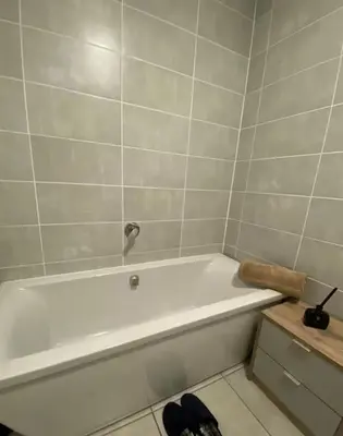 a white bath tub in a bathroom at Blyde Lagoon View Facing Crystal 2 Large Bedrooms in Pretoria