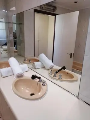 a bathroom with two sinks and a large mirror at 39 Maple in Pretoria