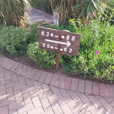 a sign on the side of a brick walk way at Travellor's relaxation unit, secure 1,5 bedrooms in Sandton