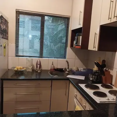 a kitchen with a sink and a counter top at Travellor's relaxation unit, secure 1,5 bedrooms in Sandton
