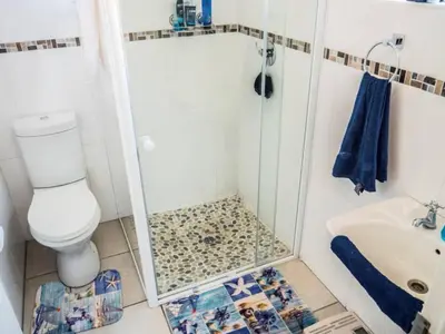 a bathroom with a shower with a toilet and a sink at Lafenis in Pretoria