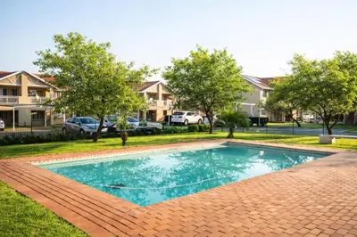 a swimming pool in a yard with houses at Lafenis in Pretoria
