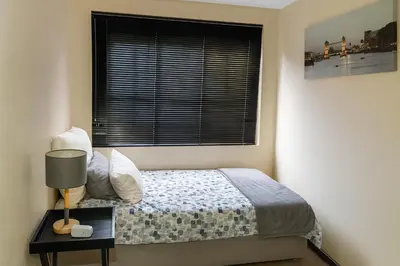 a bedroom with a bed and a window at Lafenis in Pretoria