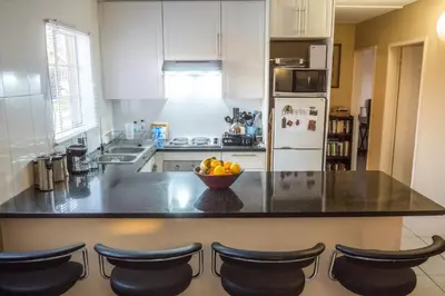 a kitchen with a counter with a bowl of fruit on it at Lafenis in Pretoria