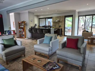 a living room with two chairs and a table at Brett's Place in Warmbaths