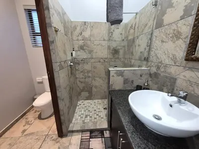 a bathroom with a sink and a toilet at Brett's Place in Warmbaths