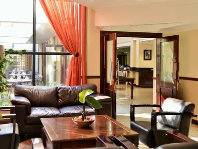 a living room with a couch and a table at Premier Hotel Pretoria in Pretoria