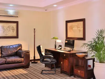 an office with a desk and a chair and a computer at Premier Hotel Pretoria in Pretoria