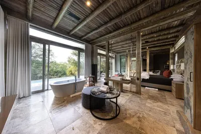 a large bathroom with a tub and a large window at Kapama Karula in Kapama Private Game Reserve