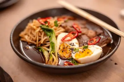 a bowl of food with eggs and noodles on a table at Kapama Karula in Kapama Private Game Reserve
