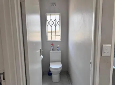 a small bathroom with a toilet and a window at River luxury home in Chartwell