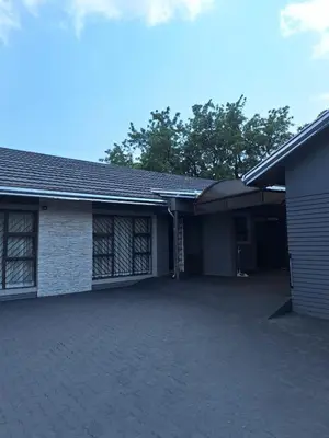 a house with a garage and a driveway at Sunrise Lodge in Phalaborwa