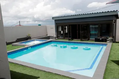 a swimming pool in the backyard of a house at Siyamthanda Boutique in Louis Trichardt